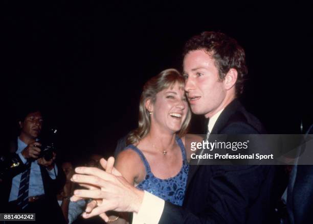 John McEnroe of the USA dancing with fellow tennis player Chris Evert-Lloyd at 'The Night of the Champions' event during the French Open Tennis...
