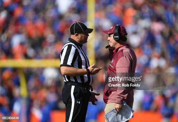 Head coach Jimbo Fisher of the Florida State Seminoles talks with an official during the game against the Florida Gators at Ben Hill Griffin Stadium...