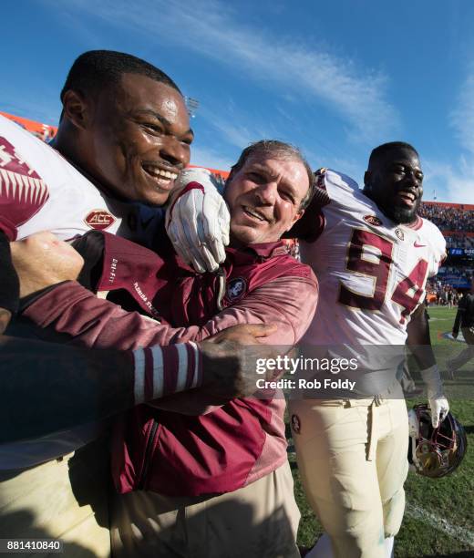 Head coach Jimbo Fisher of the Florida State Seminoles celebrates with players after the game against the Florida Gators at Ben Hill Griffin Stadium...