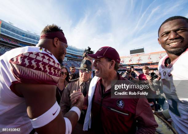 Head coach Jimbo Fisher of the Florida State Seminoles celebrates with players after the game against the Florida Gators at Ben Hill Griffin Stadium...