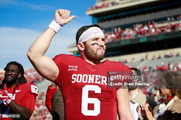 Quarterback Baker Mayfield of the Oklahoma Sooners gestures to the crowd after Senior Day announcements before the game against the West Virginia...