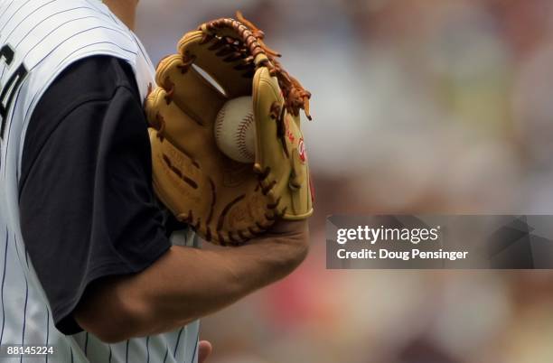 Starting pitcher Jorge De La Rosa of the Colorado Rockies holds the ball in his glove as he delivers against the San Diego Padres during MLB action...