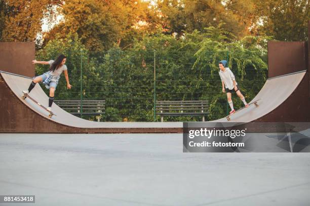 skaters in skating bowl - sports ramp stock pictures, royalty-free photos & images