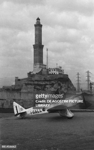 Breda Ba 39 tourist plane with the Lanterna lighthouse in the background, May 19 Genoa port, Italy, 20th century.