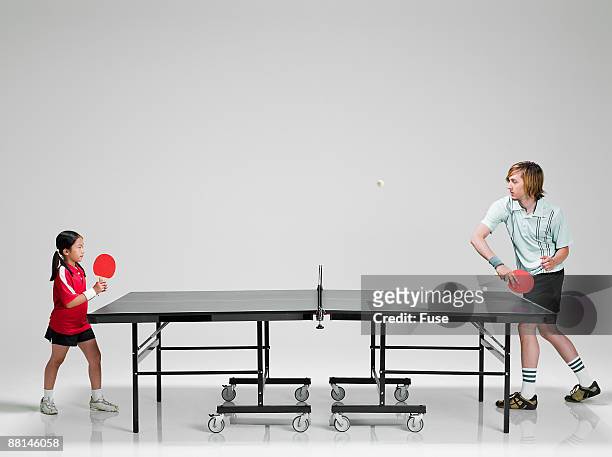 man playing young girl in ping pong - generation gap stock pictures, royalty-free photos & images