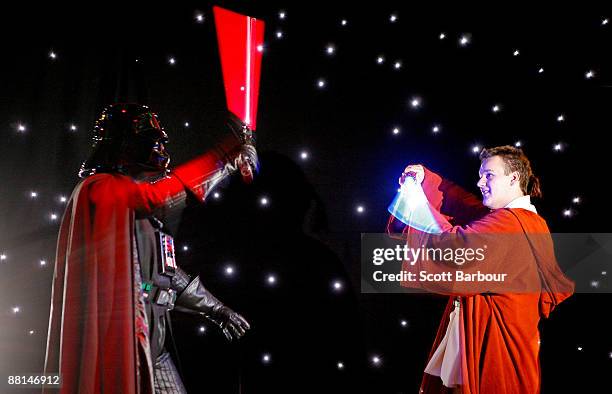 Actors dressed as Darth Vader and Luke Skywalker have a lightsaber battle during a preview to the 'Star Wars: Where Science Meets Imagination'...