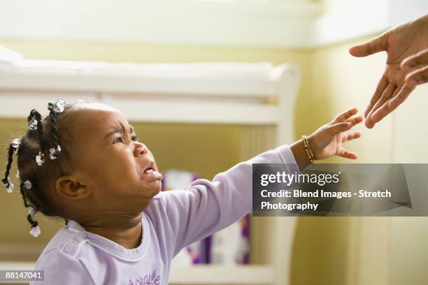 african girl crying and reaching upward - children in need stock-fotos und bilder