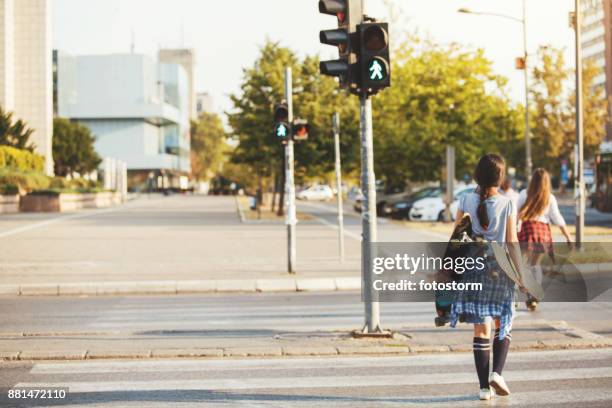 skaters crossing the street - walk signal stock pictures, royalty-free photos & images