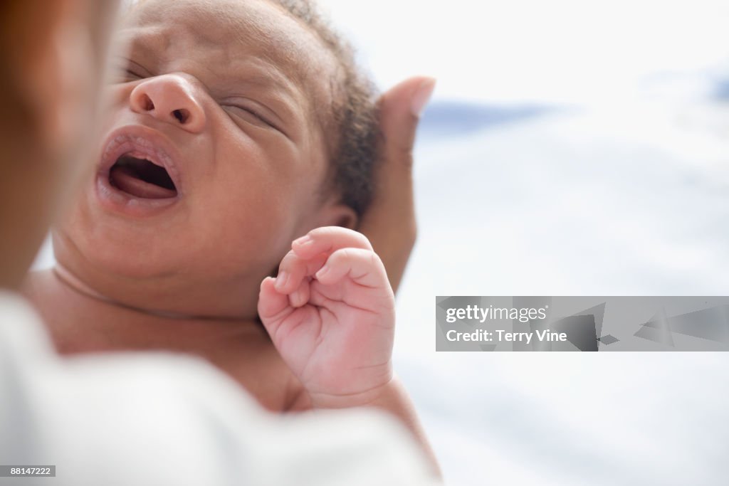 Close up of crying African newborn baby