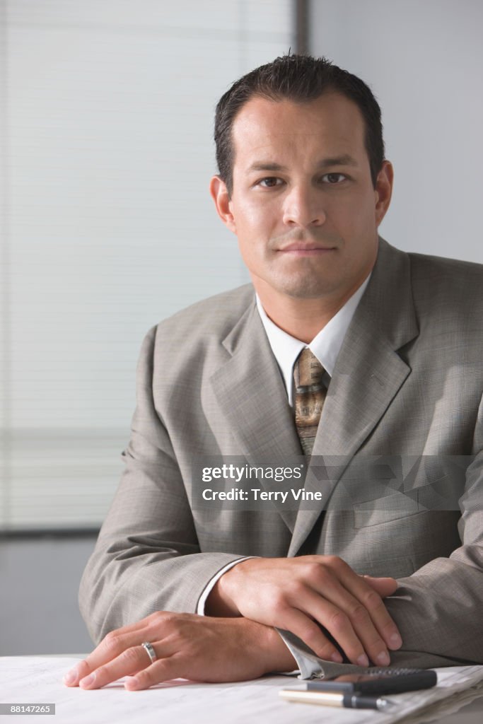 Hispanic businessman sitting at desk