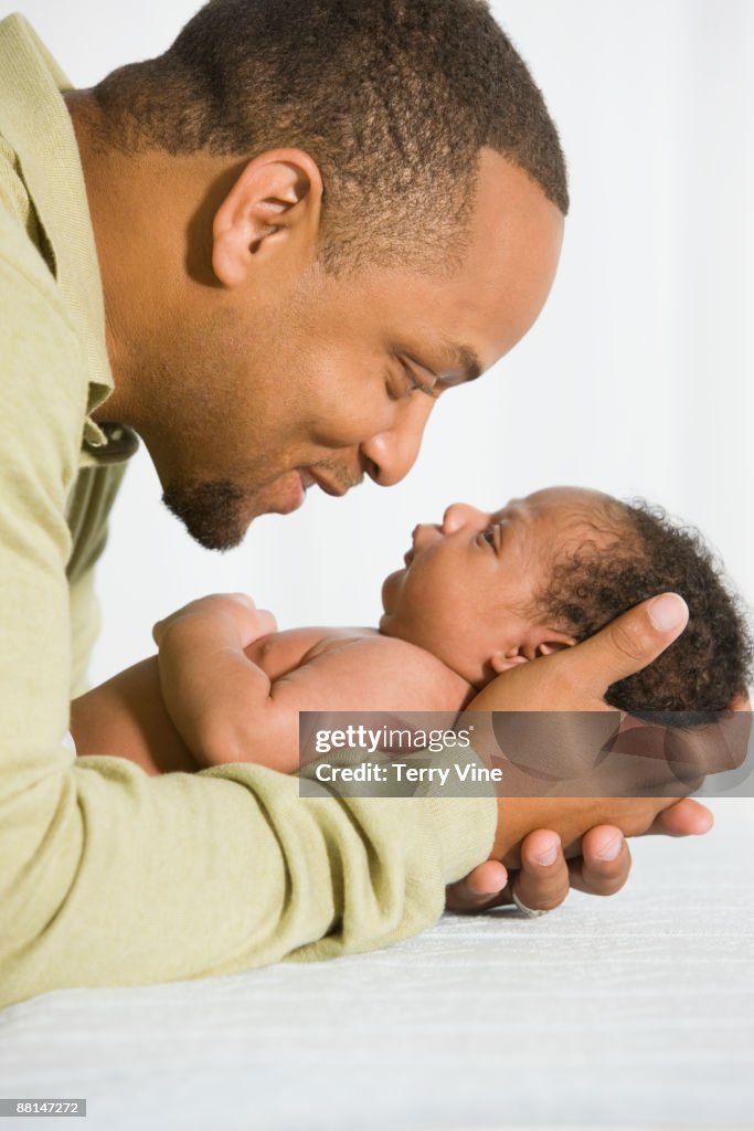 African father looking at newborn baby