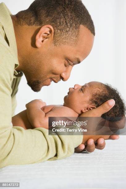 African Father Looking At Newborn Baby, Foto de stock