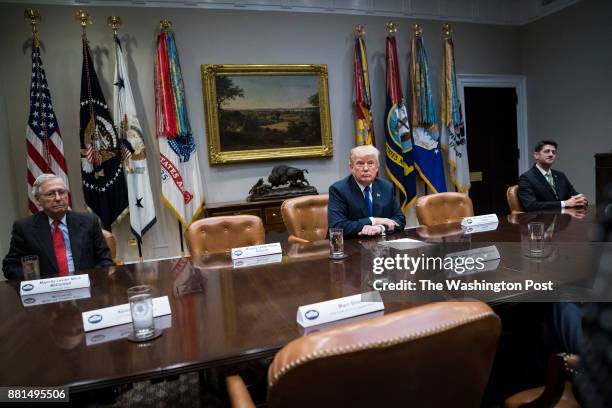 President Donald Trump speaks with House Speaker Paul Ryan of Wis., and Senate Majority Leader Mitch McConnell of Ky., by his side during a meeting...