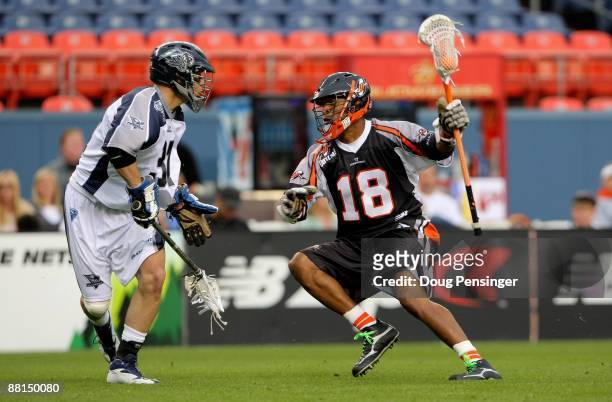 Kyle Harrison of the Denver Outlaws controls the ball as Benson Erwin of the Washington Bayhawks defends during Major League Lacrosse action at...
