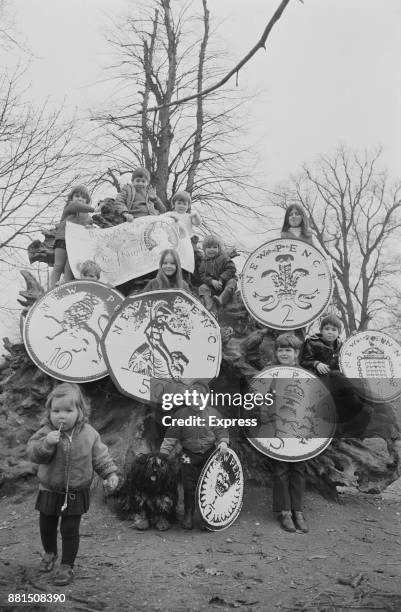 Schoolchildren with jumbo sized decimal coins, Surrey, UK, 15th February 1971.