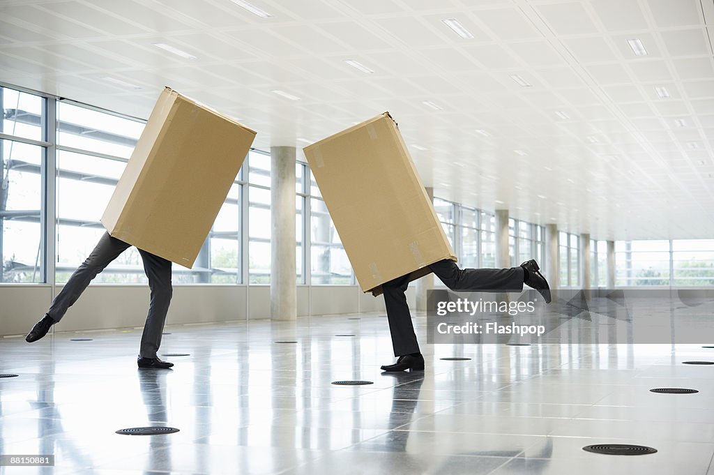 Portrait of two men in cardboard boxes