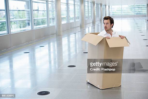 portrait of man inside cardboard box - empty office one person stock pictures, royalty-free photos & images