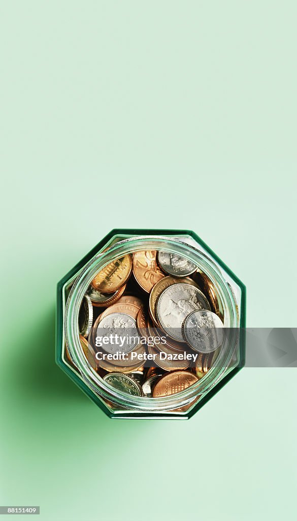 Sterling coins in savings jar.