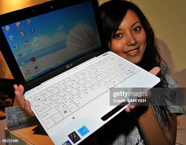 Woman displays a leatest Asus notebook Eee PC during Computex 2009 in Taipei on June 2, 2009. Asia's biggest information technology trade show opened...