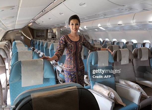 An air hostess poses in the economic class on June 2, 2009 in Roissy-en-France, northern suburb of Paris, in an Airbus A380, after the world's...