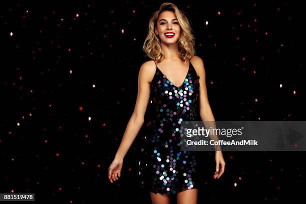 woman dancing on a party over black background with confetti - evening gown stock pictures, royalty-free photos & images