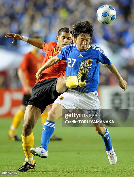 Belgium midfielder Faris Haroun battles for the ball with Japan midfielder Hideo Hashimoto during the second half of their Kirin Cup football...