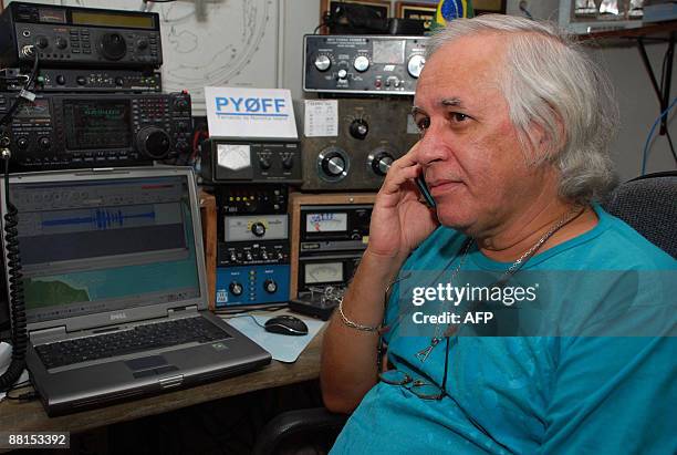 Brazilian radio ham Andre Sampaio, based in Fernando de Noronha island, talks on a mobile phone on June 2, 2009. Sampaio got and recorded a...