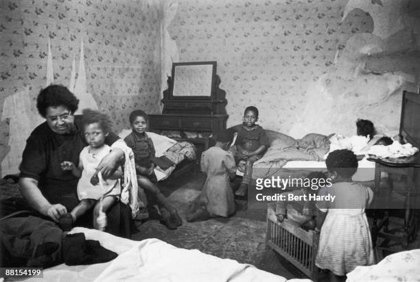 Members of a West Indian immigrant family in their bedroom, 1949. Original publication: Picture Post - 4825 - Is There A British Colour Bar - pub....