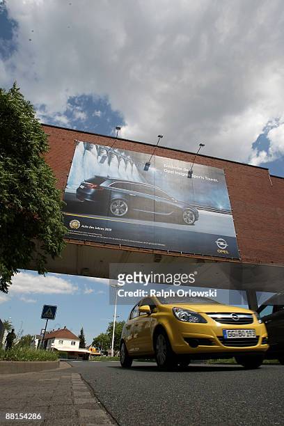 Huge advertisement poster shows an Opel Insignia at the plant of German carmaker Adam Opel GmbH, a subsidiary company of U.S. Carmaker General Motors...