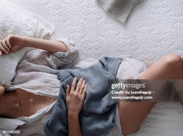cozy girl lying in bed holding a banket - cozy white blanket stock pictures, royalty-free photos & images