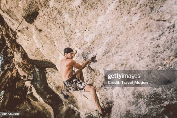 rock climbing bouldering at railay beach, thailand - railay beach stock pictures, royalty-free photos & images