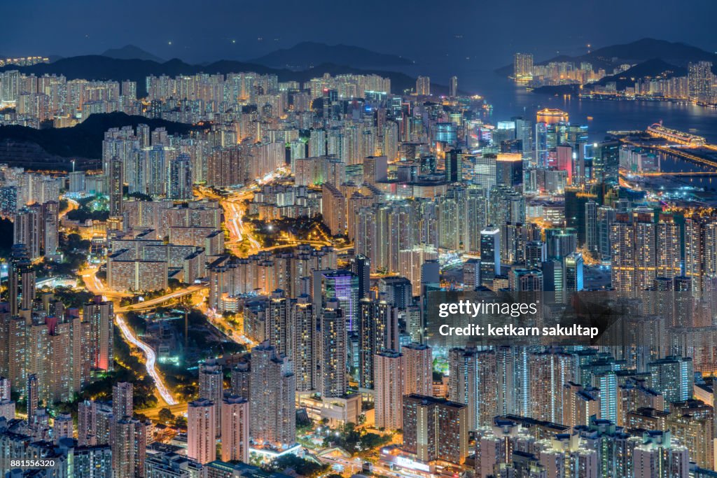 A view of Hong kong urban road and high density of tall buildings at night.