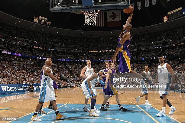 Kobe Bryant of the Los Angeles Lakers dunks the ball between Chauncey Billups, Carmelo Anthony, and Nene of the Denver Nuggets in Game Six of the...