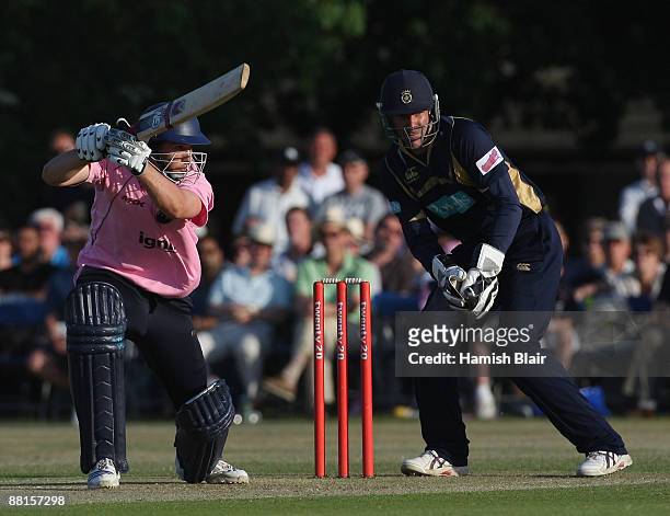 Billy Godleman of Middlesex cover drives with Nic Pothas of Hampshire looking on during the Twenty20 match between Middlesex and Hampshire at The...