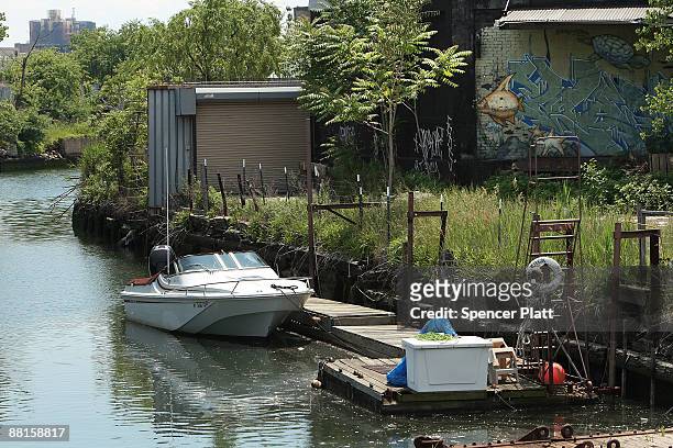 Private boat is docked along the Gowanus Canal on June 2, 2009 in the Brooklyn borough of New York City. The Gowanus Canal is bounded by several...