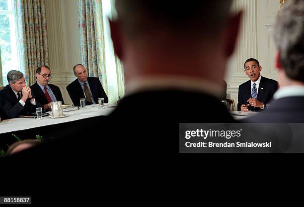 Senator Sheldon Whitehouse , strategist David Axelrod and others listen while U.S. President Barack Obama speaks before a meeting in the State Dining...