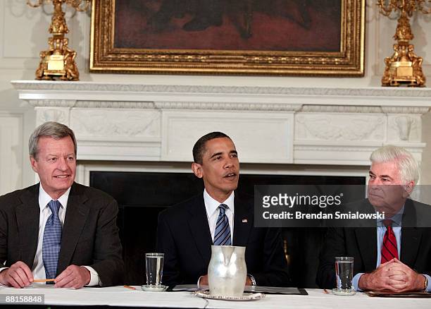 Senator Max Baucus and Senator Christopher Dodd listen to U.S. President Barack Obama speak before a meeting in the State Dining Room of the White...
