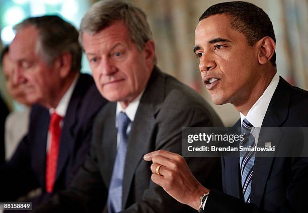 Senator Tom Harkin and Senator Max Baucus listen to U.S. President Barack Obama speak before a meeting in the State Dining Room of the White House...