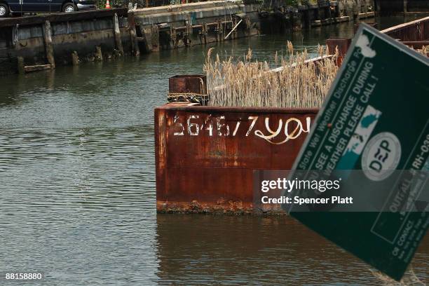 Sign from the Department of Environmental Protection hangs near the polluted Gowanus Canal on June 2, 2009 in the Brooklyn borough of New York City....