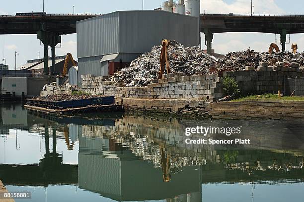 Scrap heap sits next to the polluted Gowanus Canal on June 2, 2009 in the Brooklyn borough of New York City. The Gowanus Canal is bounded by several...