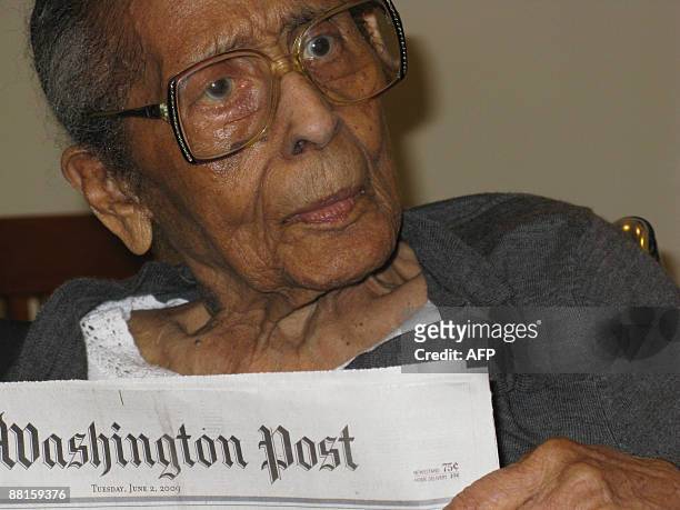 Hurricane Katrina survivor Gerladine Minor holds a newspaper on the day of her 100th birthday on June 2nd, 2009 in Washington, DC just one day after...