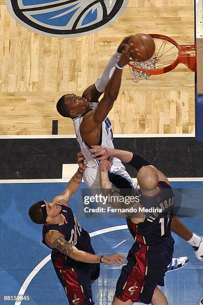 Dwight Howard of the Orlando Magic slam dunks over Delonte West and Zydrunas Ilgauskas of the Cleveland Cavaliers in Game Six of the Eastern...