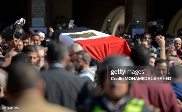 Mourners carry the bier of the late popular singer and actress Shadia, draped with an Egyptian flag, during her funeral at the Sayeda Nafisa mosque...