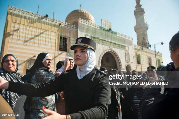 Policewomen organise mourners attending the funeral of the late popular singer and actress Shadia, at the Sayeda Nafisa mosque in the capital Cairo...