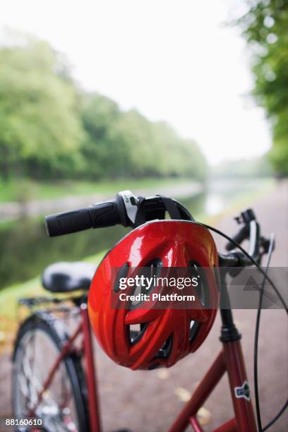 a bicycle and a safety helmet sweden. - cykelhjälm bildbanksfoton och bilder