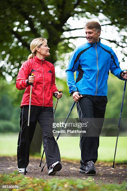 a couple power walking in a park sweden. - northern european ストックフォトと画像