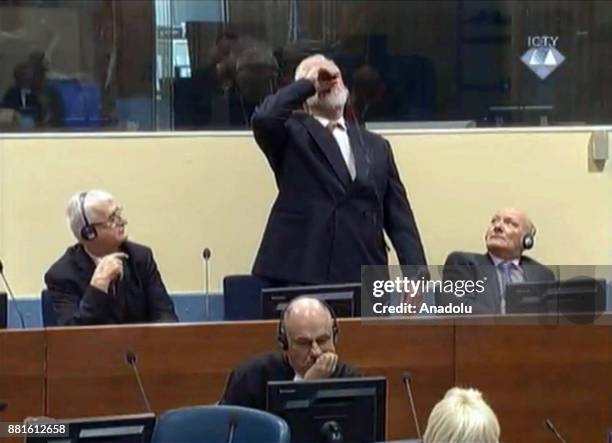 Photo provided by ICTY shows, Crotian Former General Slobodan Praljak drinking a small bottle of liquid claimed to be poison after judges reconfirmed...