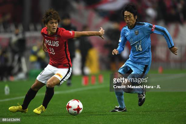 Kengo Nakamura of Kawasaki Frontale and Toshiyuki Takagi of Urawa Red Diamonds compete for the ball during the J.League J1 match between Urawa Red...