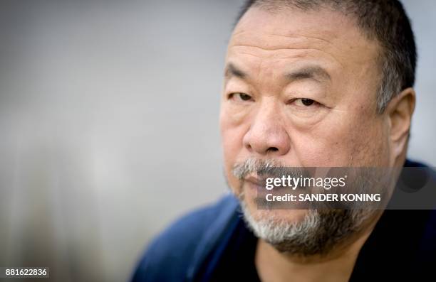 Chinese dissident artist Ai Weiwei poses during the Amsterdam Light Festival in Amsterdam on November 29, 2017. Original artworks by Weiwei will be...