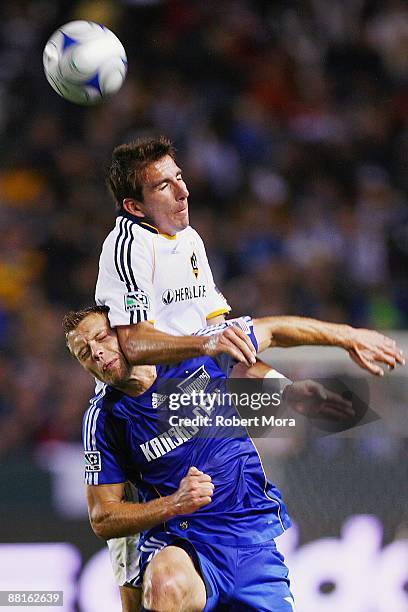 Alan Gordon of the Los Angeles Galaxy hits defender Aaron Hohlbein of the Kansas City Wizards while attempting to head a loose ball during their MLS...